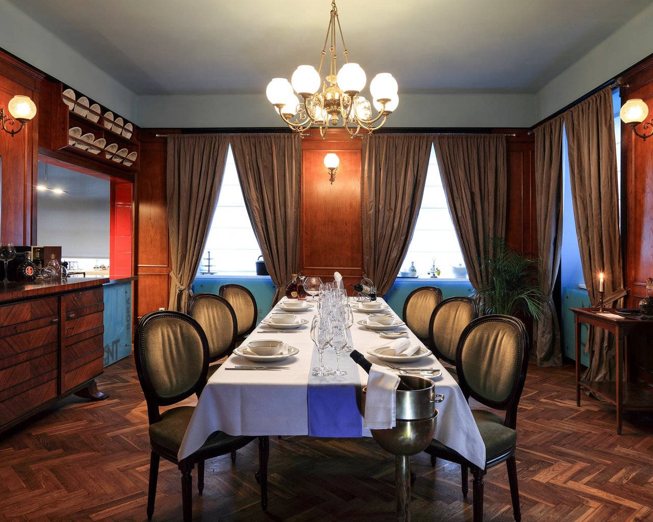 A restaurant table in the middle of the room, with glasses and dishes
