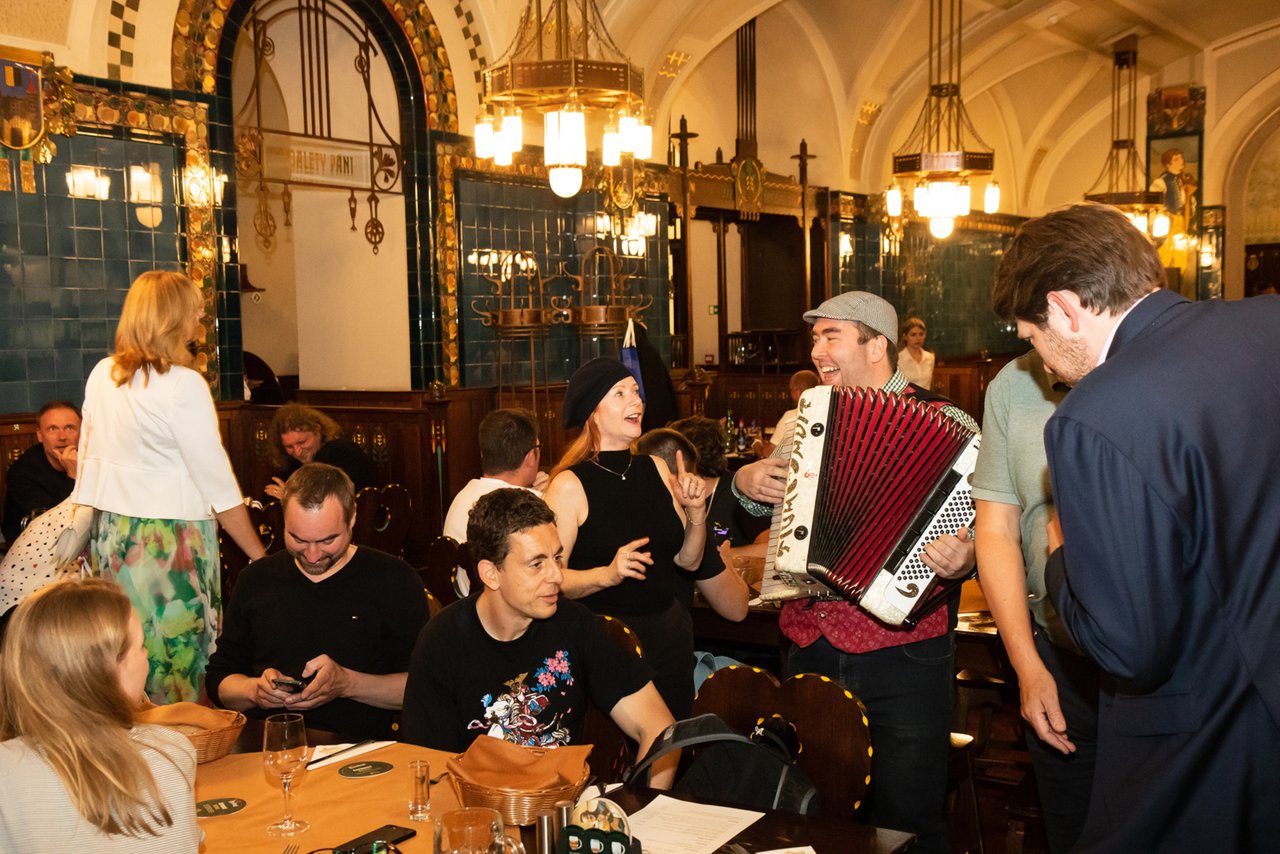 Large rooms filled with people and tables set close together