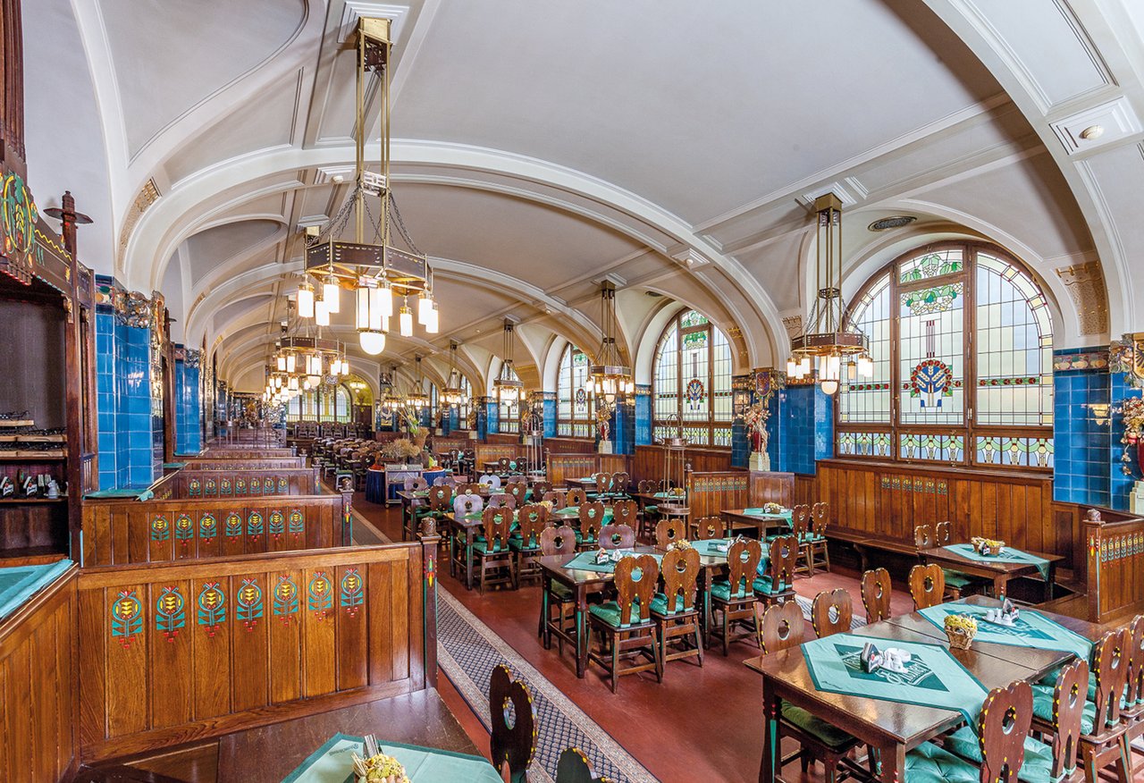 A large room with a vaulted ceiling and lots of tables
