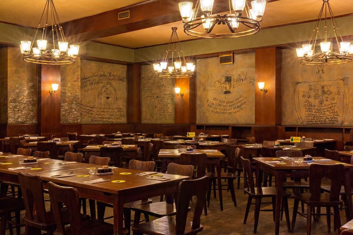 A large dining room whose walls are adorned with inscriptions and drawings